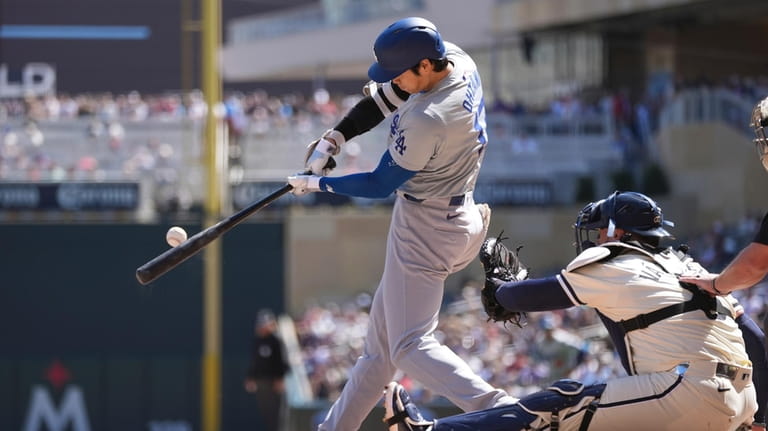 Los Angeles Dodgers designated hitter Shohei Ohtani hits a single...