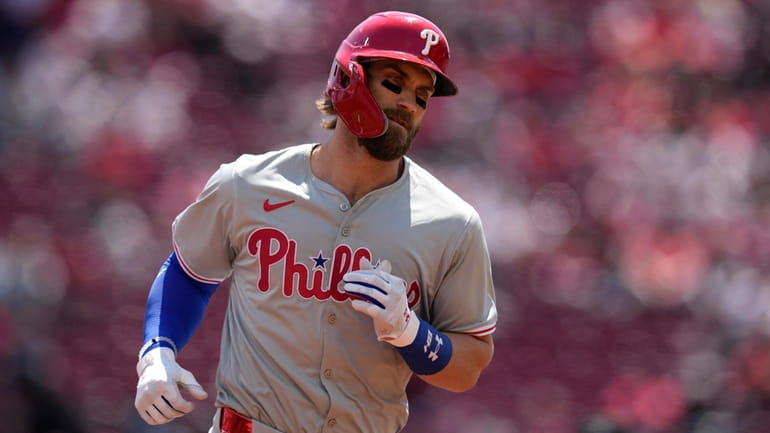 Philadelphia Phillies' Bryce Harper rounds the bases after hitting a...