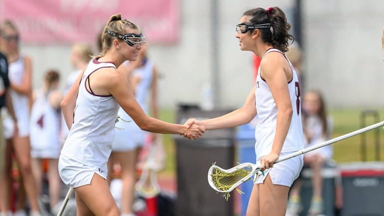 Garden City’s Kendal Morris and Grace Hopkins shake on it during girls lacrosse state...