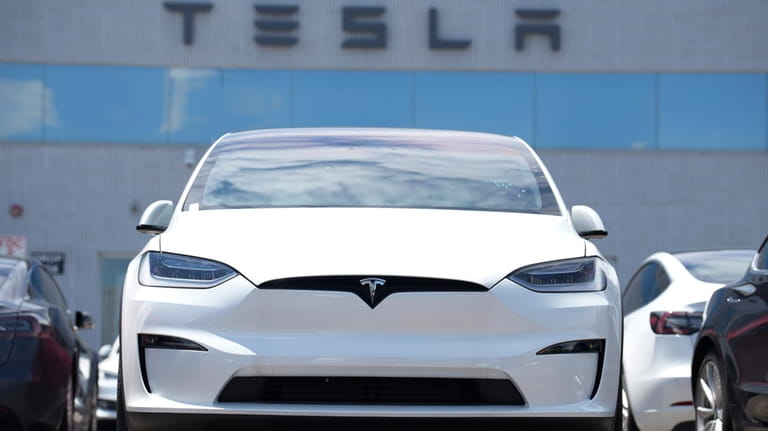 An 2023 Model X sits outside a Tesla dealership on...