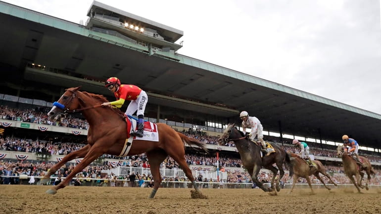 Justify (1), with jockey Mike Smith up, crosses the finish...