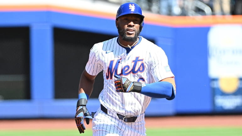 Mets' Starling Marte rounds the bases after solo home run against...