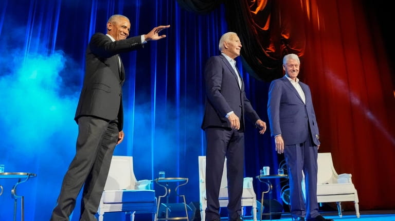 President Joe Biden, center, and former presidents Barack Obama, left,...