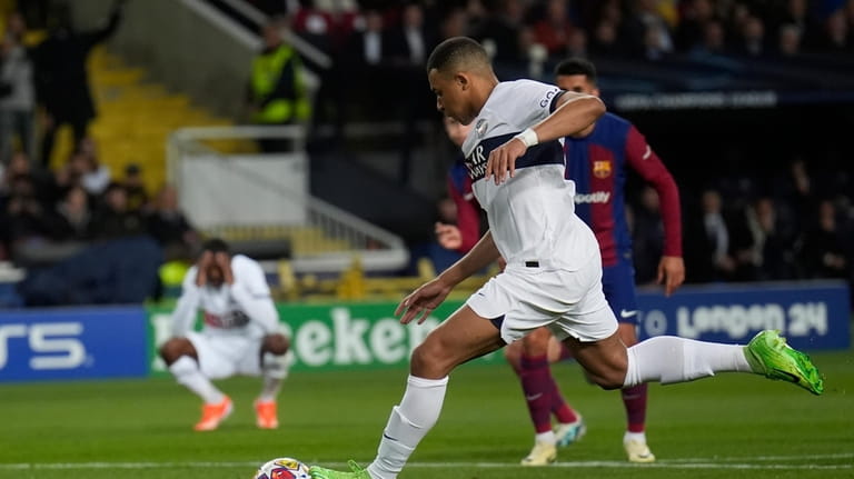 PSG's Kylian Mbappe scores his side's third goal during the...