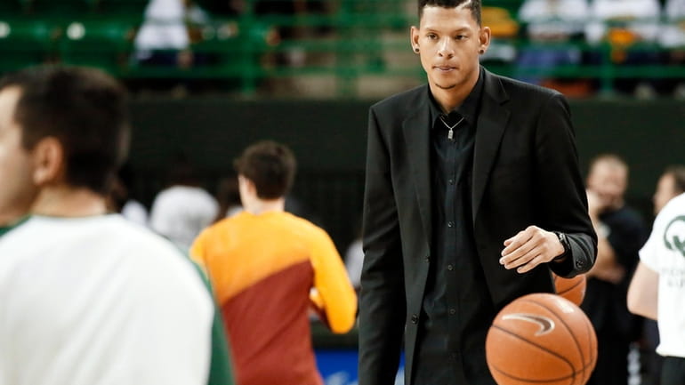 Baylor student assistant Isaiah Austin prepares to toss a ball...