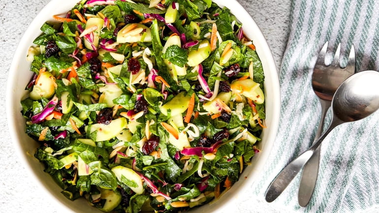 Kale slaw is made with dried cranberries, toasted almonds and...