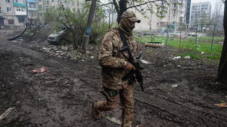 A Ukrainian soldier walks Friday in an area of the...