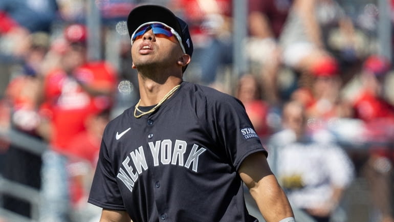 The Yankees' Oswald Peraza reacts after dropping a short pop-up hit by...