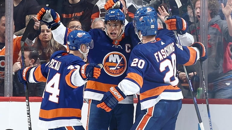 Anders Lee of the Islanders, center, reacts with teammates after scoring during...
