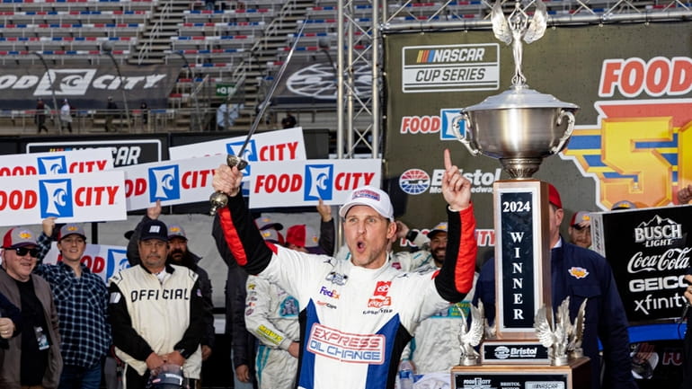 Denny Hamlin celebrates winning a NASCAR Cup Series auto race,...