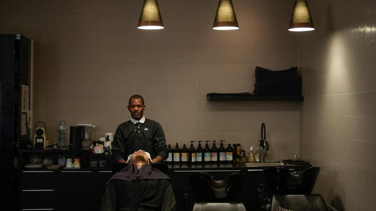 A customer has his hair shampooed in a hairdressing salon,...