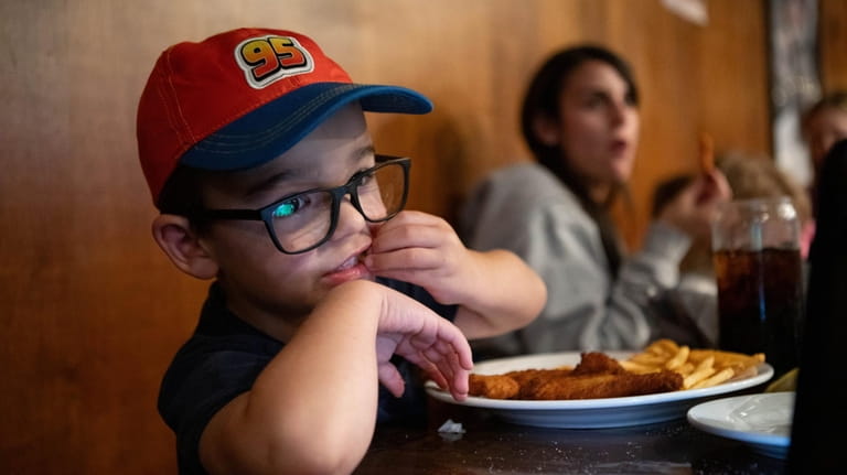 James Jaeger, 4, of Merrick has chicken fingers with fries at...