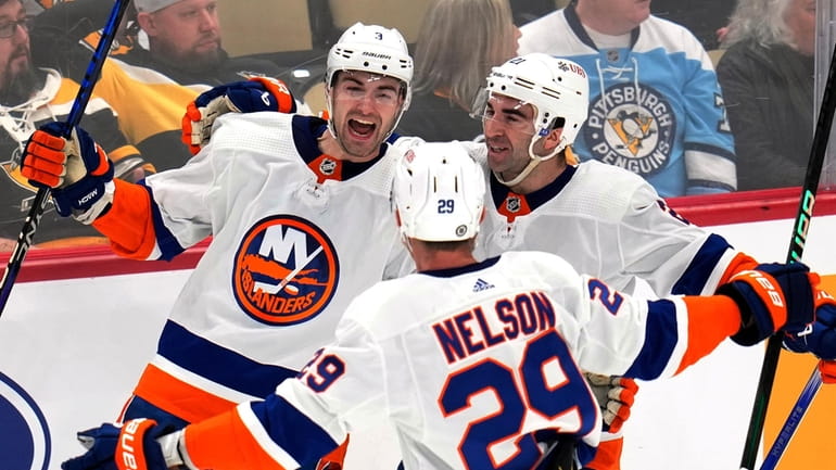 The Islanders' Adam Pelech celebrates his winning goal in overtime...