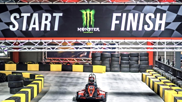 An electric go-kart racer stands by to make a run at...