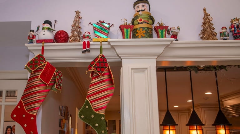 Brightly colored stockings are hung near some of the other...