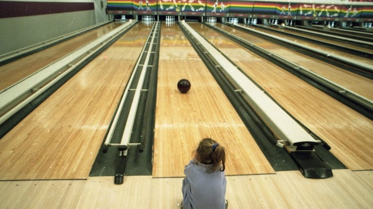 Elizabeth Northcote, then 3, watches as her bowling ball slowly...