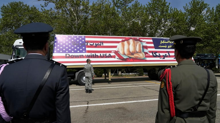 An anti-U.S. banner is carried on a truck during Army...