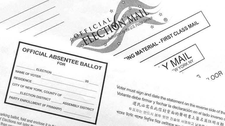 An absentee ballot sits on a table with its envelope...
