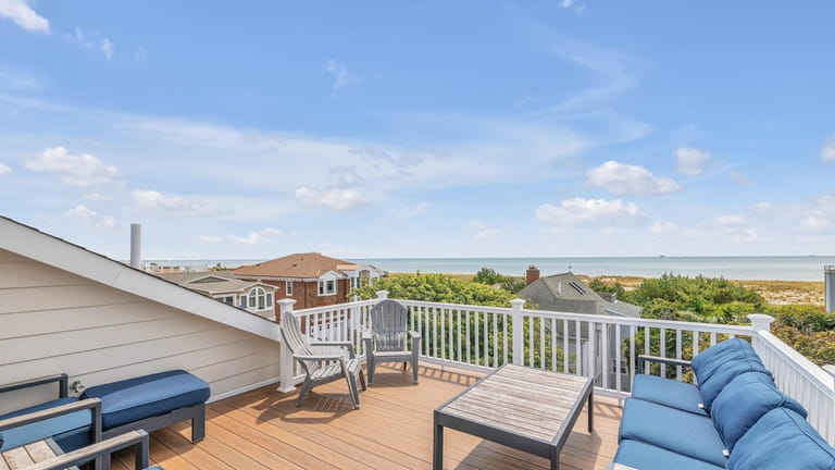 The home's rooftop deck offers panoramic views of the ocean.