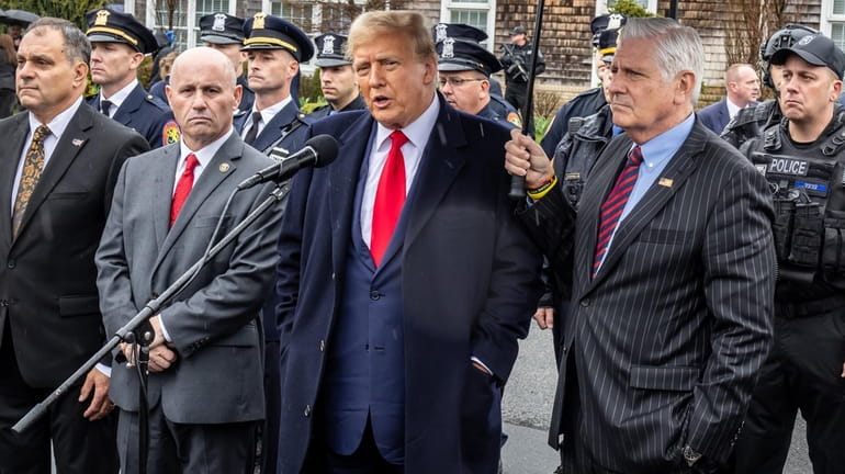 Former president Donald Trump is flanked by NCPD commissioner Patrick Ryder...