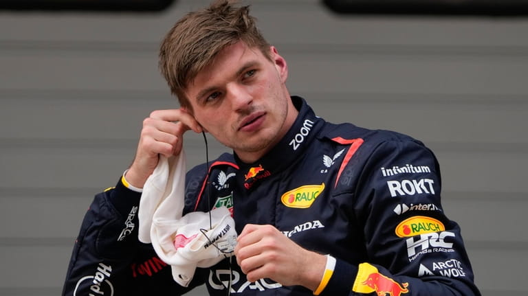 Red Bull driver Max Verstappen of the Netherlands reacts after...