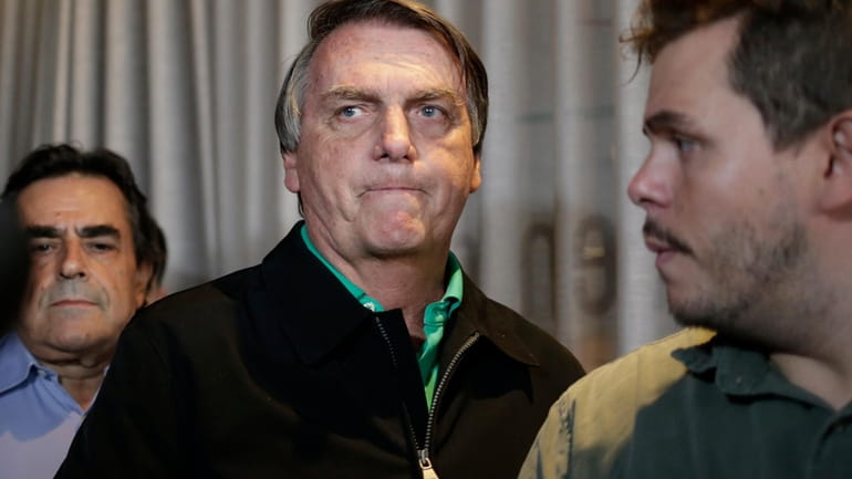 Brazil's former President Jair Bolsonaro prepares to speak to the...