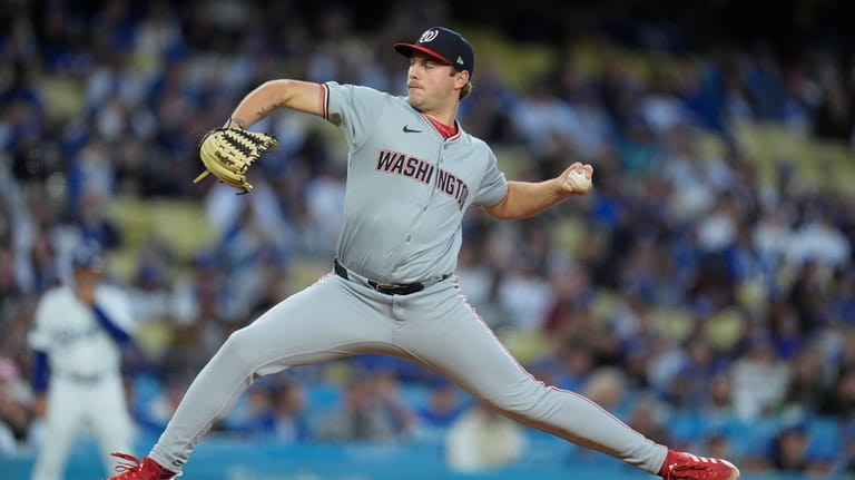 Washington Nationals starting pitcher Mitchell Parker throws to a Los...