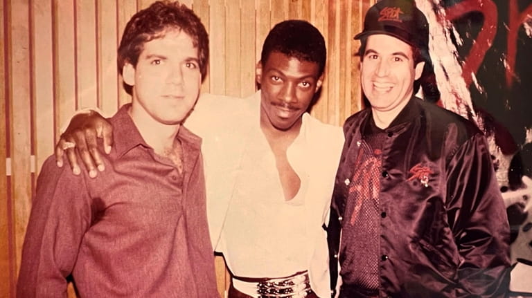 From left: promotions manager Keith Hart, comedian/actor Eddie Murphy and...