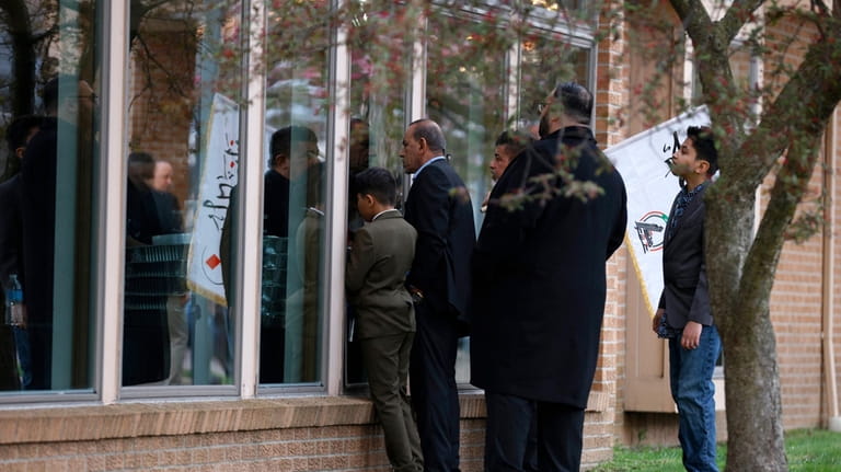 People peek in the windows outside the Islamic Institute of...