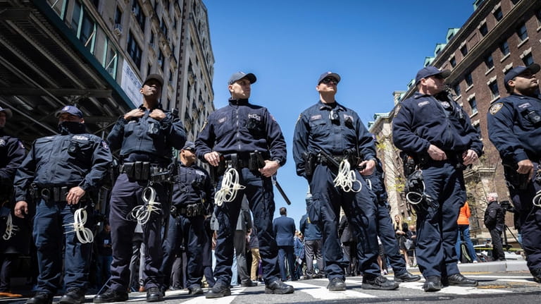 NYPD officers from the Strategic Response Group form a wall...