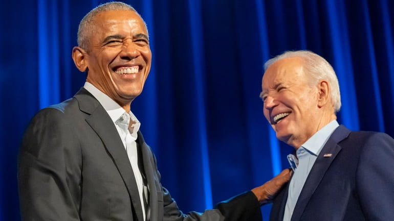 President Joe Biden, right, and former presidents Barack Obama, left,...