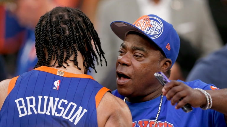 New York Knicks guard Jalen Brunson, left, hugs actor Tracy...