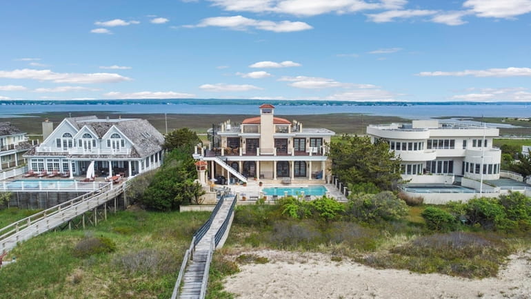 This East Quogue home, center, on Dune Road is on...