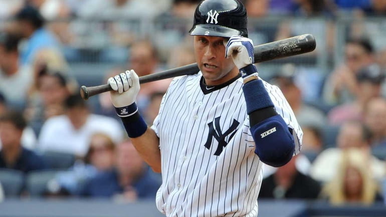 Derek Jeter #2 of the New York Yankees looks at...
