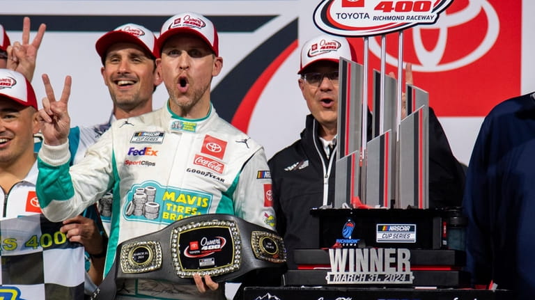Denny Hamlin celebrates after winning a NASCAR Cup Series auto...