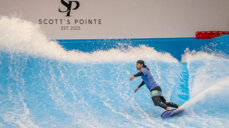 Matt East, 35, of Medford rides a wave in the...