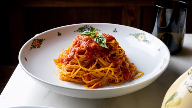Spaghetti pomodoro topped with basil at Osteria Morini at Roosevelt...