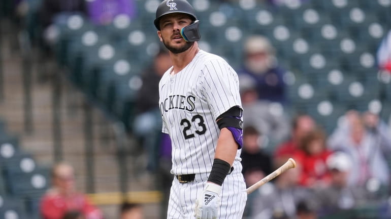 Colorado Rockies' Kris Bryant heads to the dugout after striking...