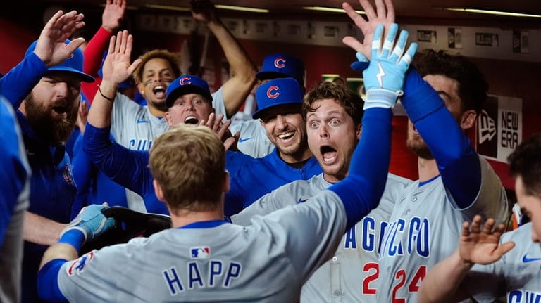 Chicago Cubs' Ian Happ, front left, celebrates his grand slam...