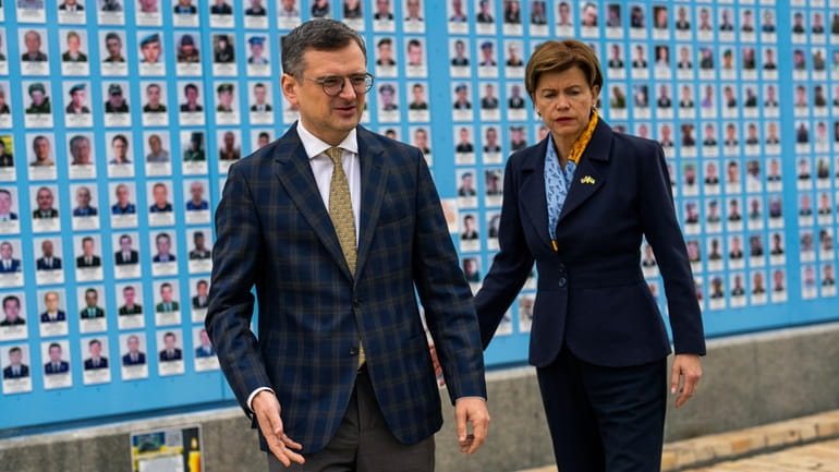 Ukraine Foreign Minister Dmytro Kuleba, left, leads his Latvia counterpart...