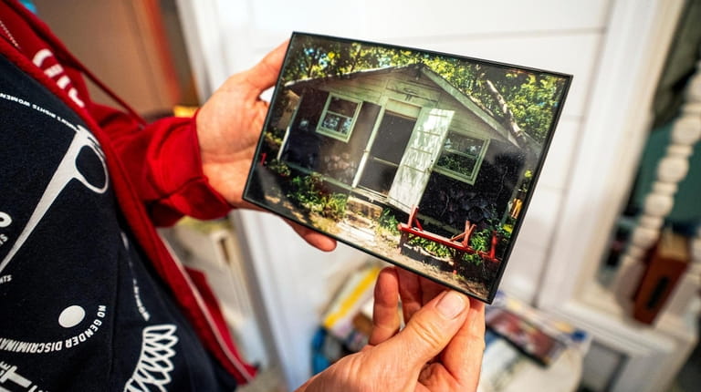 Jennifer Hoeppner with a photograph of the bungalow that her...