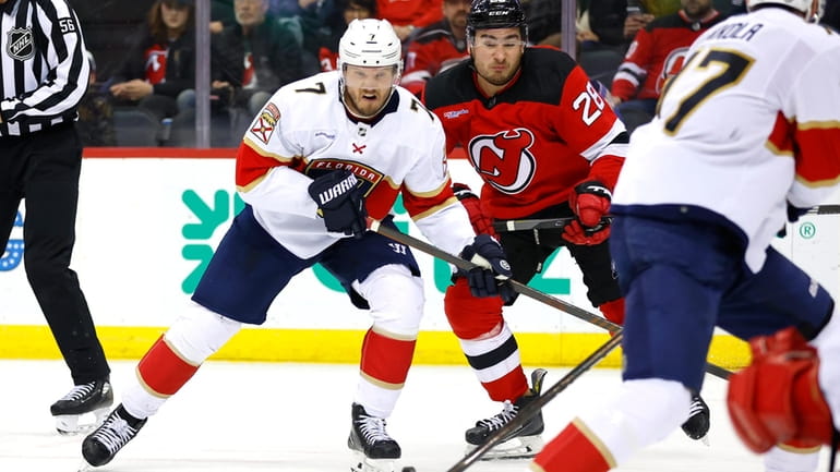 Florida Panthers defenseman Dmitry Kulikov (7) battles New Jersey Devils...