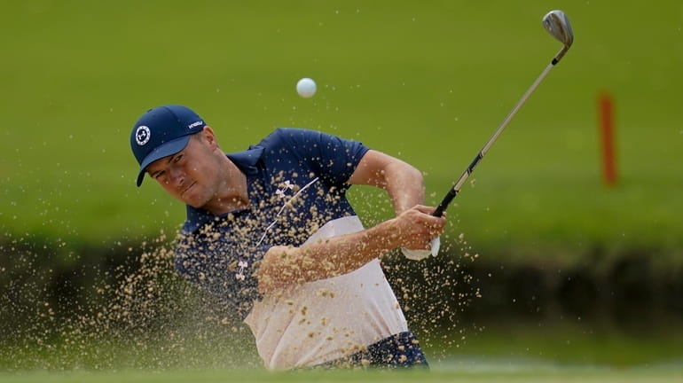 Jordan Spieth hits from the bunker on the 13th hole...
