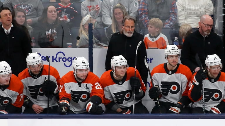 Philadelphia Flyers head coach John Tortorella, center top, looks on...