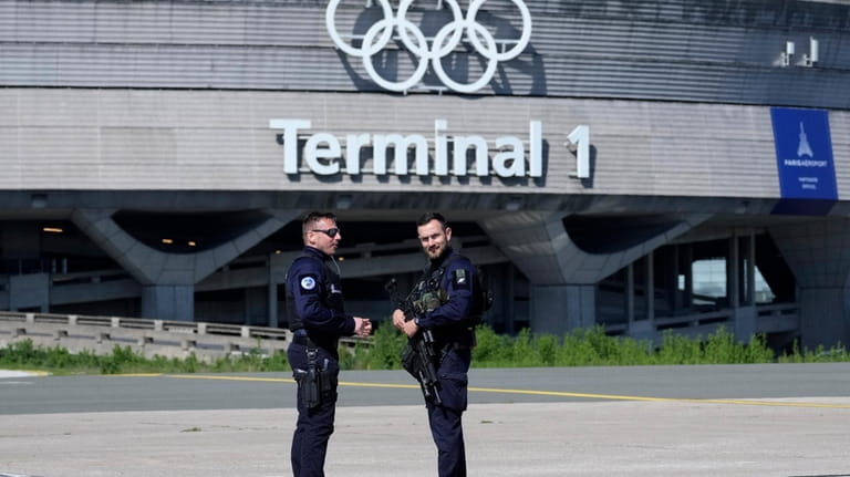 Gendarmes stand in from of the Charles de Gaulle airport,...