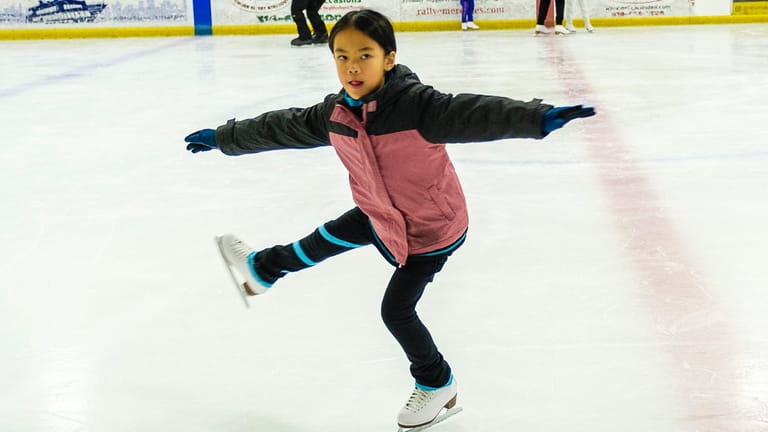 Ansley Teng, of Garden City, practices her figure skating routine...