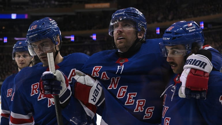 Rangers right wing Blake Wheeler is helped off the ice...