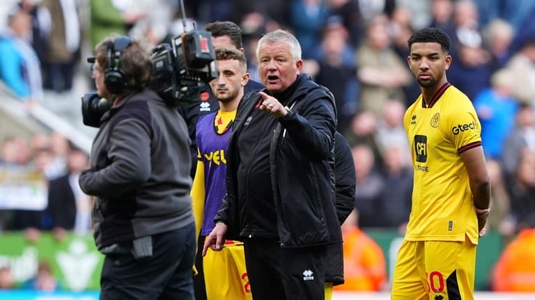 Sheffield United manager Chris Wilder, centre, reacts to the camera...