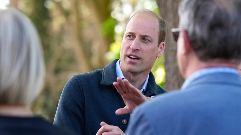Britain's Prince William is greeted as he arrives for a...