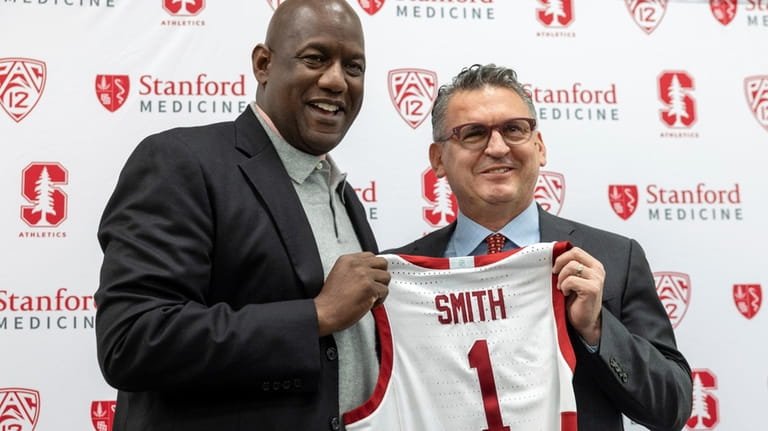 Stanford athletic director Bernard Muir, left, introduces Kyle Smith as...